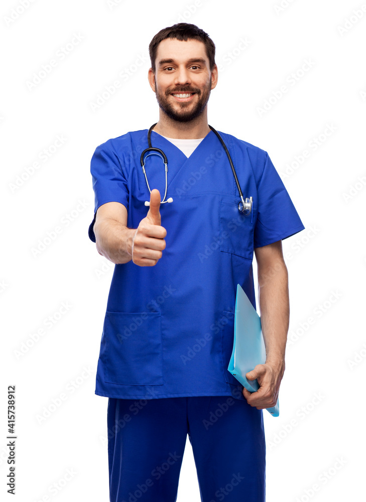 healthcare, profession and medicine concept - happy smiling doctor or male nurse in blue uniform with folder showing thumbs up over white background healthcare, profession and medicine concept - happy smiling doctor or male nurse in blue uniform with folder showing thumbs up over white background