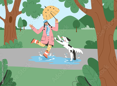 Young girl with umbrella walking dog in park