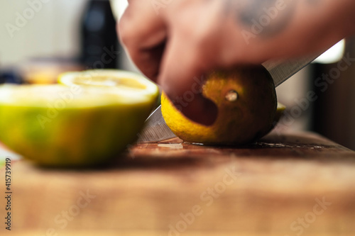 Cutting limes by chef for Mexican dish photo