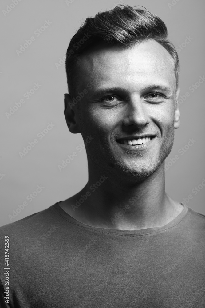 Fabulous at any age. Portrait of handsome 30-year-old man standing over gray background. Close up. Classic style. Shiny white smile. Headshot. Studio shot Fabulous at any age. Portrait of handsome 30-year-old man standing over gray background. Close up. Classic style. Shiny white smile. Headshot. Studio shot