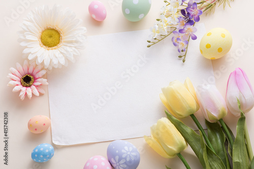 Happy Easter day colorful eggs and flower decoration on paper background with copy space