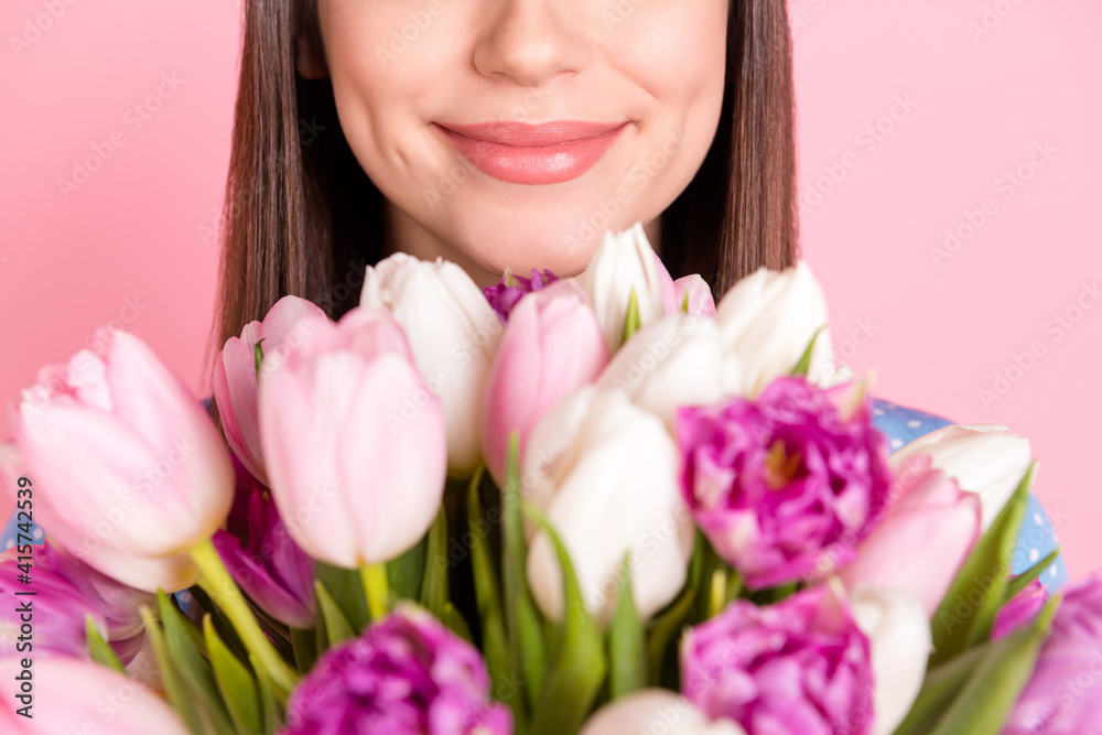 Photo of young beautiful lovely good mood dreamy girl smell sniff bouquet flowers isolated on pink color background Photo of young beautiful lovely good mood dreamy girl smell sniff bouquet flowers isolated on pink color background