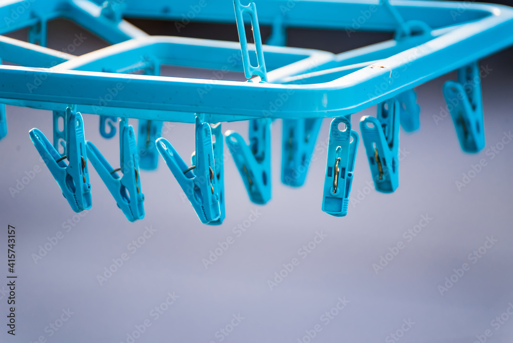 Blue plastic clothes pegs. Natural living and lifestyle concept. Shallow depth of field and selective focus Blue plastic clothes pegs. Natural living and lifestyle concept. Shallow depth of field and selective focus