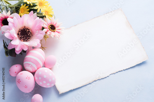 Happy Easter day pink eggs and flower decoration on paper background with copy space