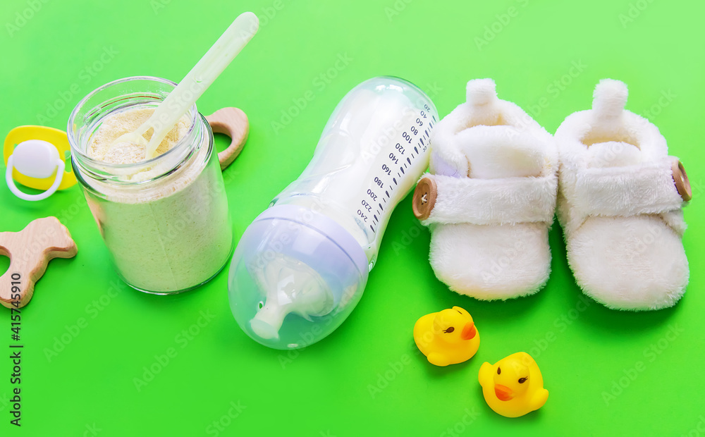 various accessories for babies. green background. selective focus. various accessories for babies. green background. selective focus.