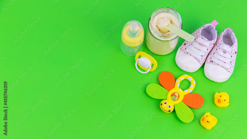 various accessories for babies. green background. selective focus.