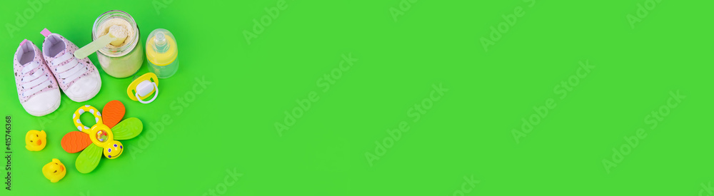 various accessories for babies. green background. selective focus. various accessories for babies. green background. selective focus.