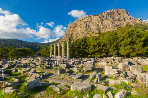 Scenic view of ruins of Temple of Athena at foot of escarpment of Mycale in ancient Greek city of Priene on sunny winter day, Turkey photo