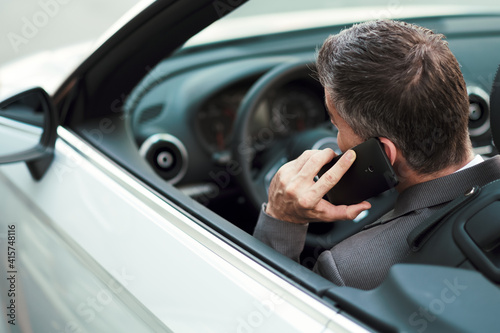 Businessman driving and phone calling