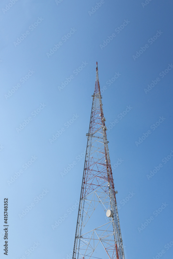 communication construction pole on clear blue sky. the high radio antenna tower on clearly blue sky background in thailand. communication construction pole on clear blue sky. the high radio antenna tower on clearly blue sky background in thailand.