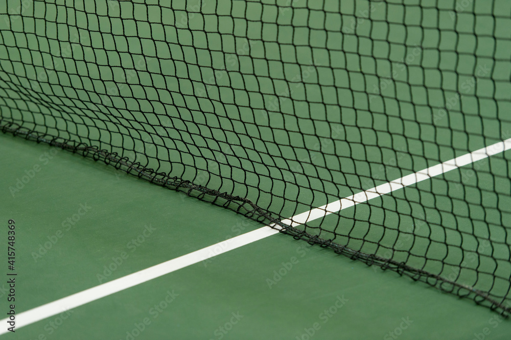 Green paddle tennis net and hard court. Tennis compettion concept Green paddle tennis net and hard court. Tennis compettion concept
