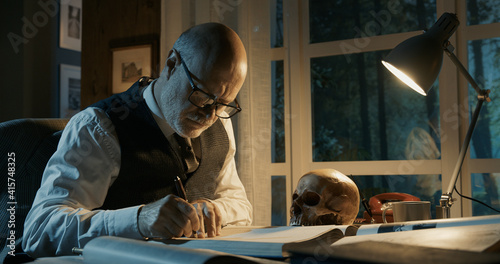 Academic professor studying a human skull photo