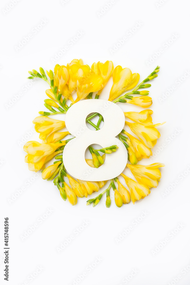 Beautiful yellow freesia and number eight isolated on white background. Greeting card international women day on march 8th