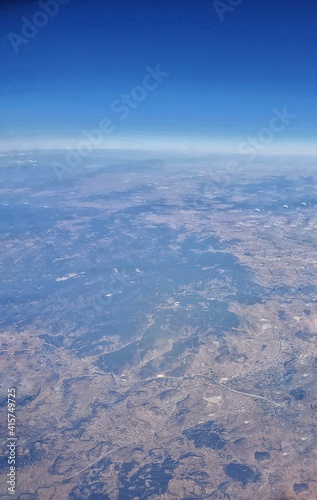 Clouds and sky as seen through window of an aircraft