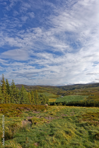 A Small White Scottish Castle seen in the distance in the Hills of Cromdale on the small road out of the Highland Village of Tomintoul.