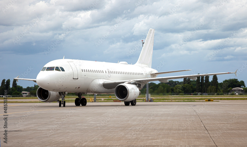 Passanger white plane lands. Blue airplane on the platform of Airport. Runway. Landing aircraft.