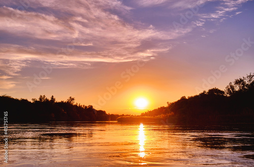 Magic atmosphere of a romantic evening  golden sunset on the river