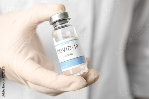 Doctor holding vial with vaccine against Covid-19, closeup