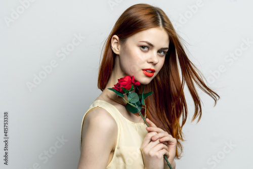 attractive red-haired woman red lips rose flower in hands charm