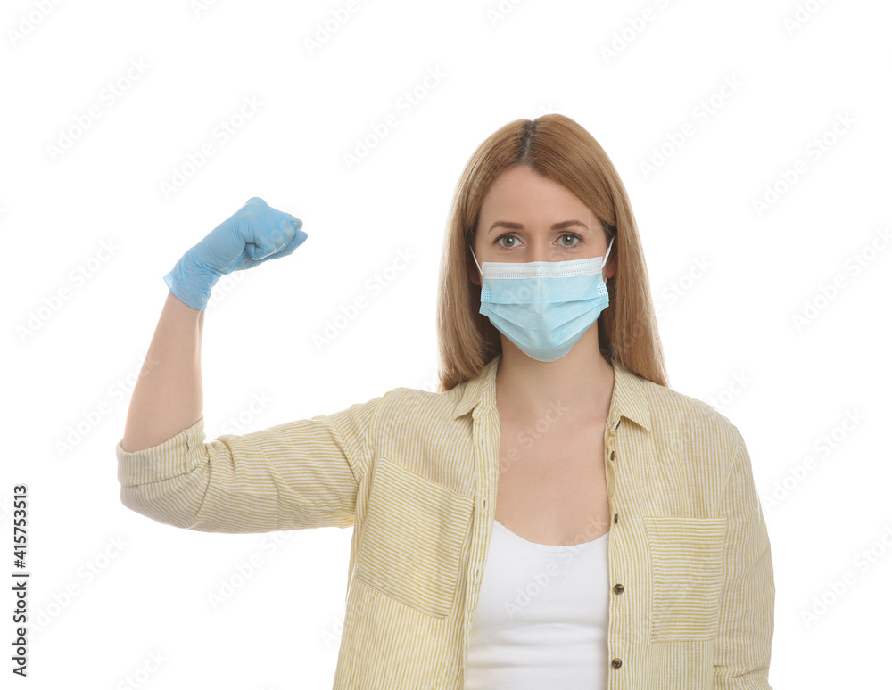 Woman with protective mask and gloves showing muscles on white background. Strong immunity concept Woman with protective mask and gloves showing muscles on white background. Strong immunity concept