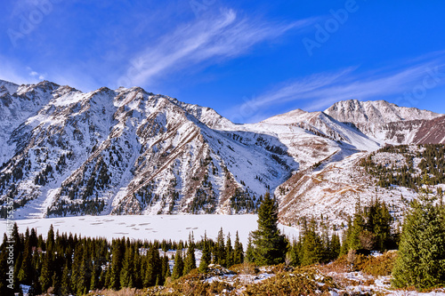 Alpine landscape with frozen lake; texture and pattern of a frozen alpine lake in the winter season; Big Almaty lake in Kazakhstan