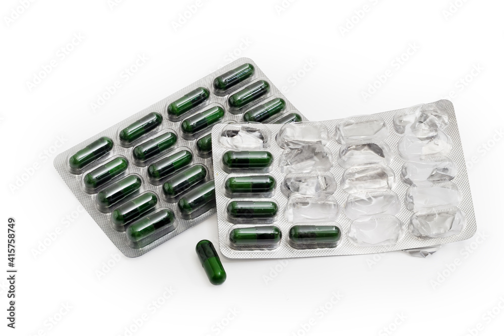 Green capsules in full packing and in started blister packing