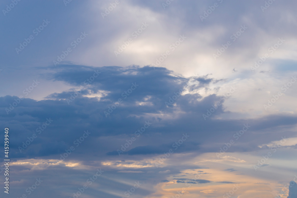 A picturesque blue-orange sky in pastel colors at sunset. Natural background of a cloudy sky
