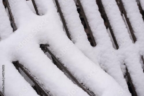 Geometric stripes of snow on wooden planks. Abstract background.