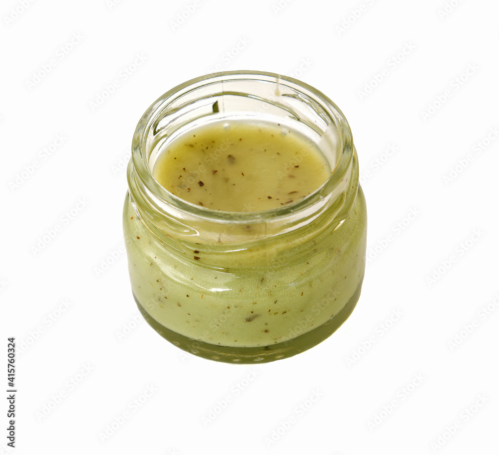 Pistachio honey-souffle in small jar on white background Pistachio honey-souffle in small jar on white background