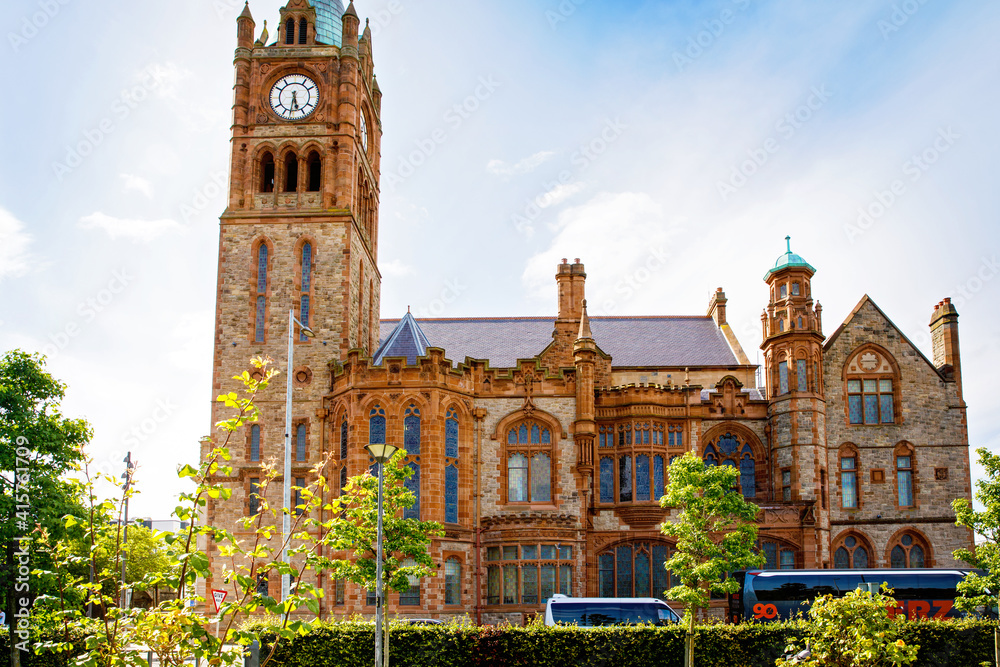Fototapeta premium Derry, North Ireland. Aerial view of Derry Londonderry city center in Northern Ireland, UK. Sunny day with cloudy sky, city walls and historical buildings