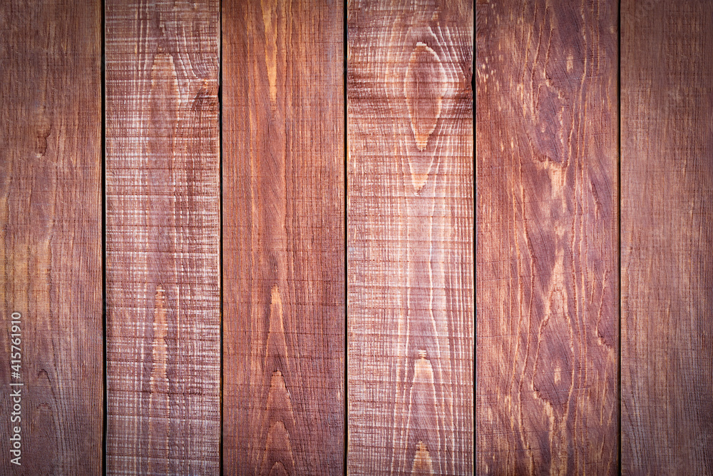 Fototapeta premium Old rustic dark brown boards. Close-up. Vertical wooden planks with texture. Natural surface background. Textured backdrop