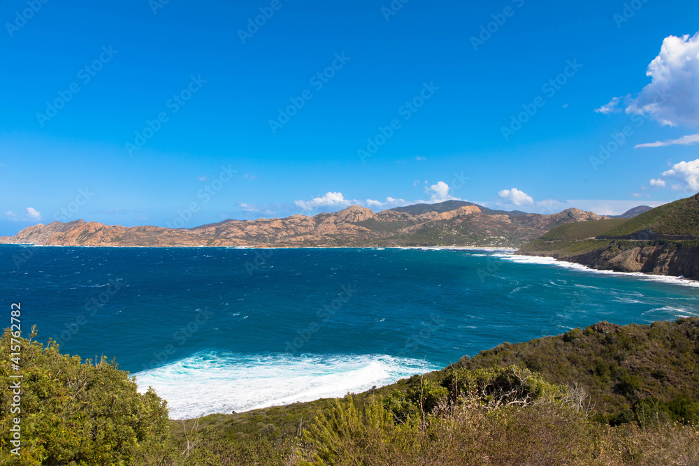 Panoramic view of the mediterranean sea and the mountain range in the background. Cap Corse, Corsica, France. Tourism and vacations concept.