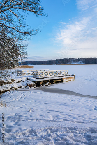 View of the wooden pier and the sea shore in winter, Dagmar park, Kallviken, Raseborg, Finland photo