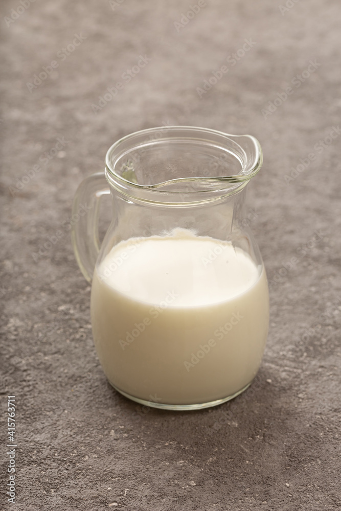 Jug of fresh milk close up on gray concrete. top view Jug of fresh milk close up on gray concrete. top view