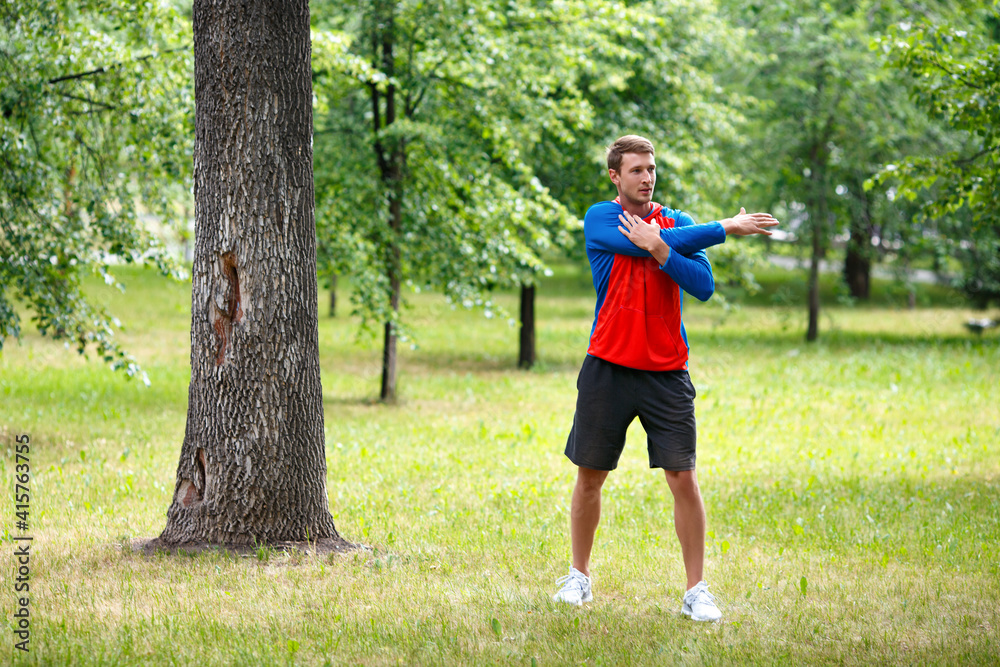 Photo of a man stretcing muscles - sport and healthy lifestyle concept. Full-length photo. Photo of a man stretcing muscles - sport and healthy lifestyle concept. Full-length photo.
