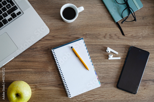 Fotografie Wooden desk table with different office items