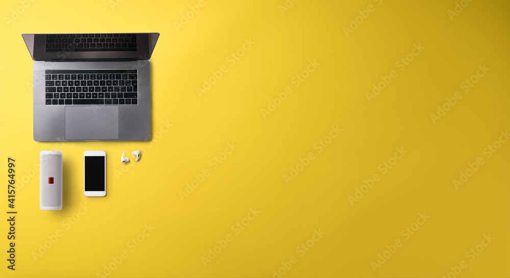 Flat lay top view office desk working space with laptop on yellow background. Copy space. Flat lay top view office desk working space with laptop on yellow background. Copy space.
