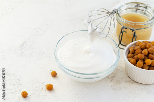 Whipped aquafaba with boiled chickpeas on a light table.
