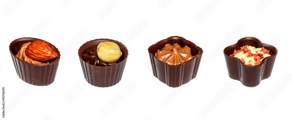 Four chocolates with cream and nuts. Assorted chocolate on white isolated background Four chocolates with cream and nuts. Assorted chocolate on white isolated background
