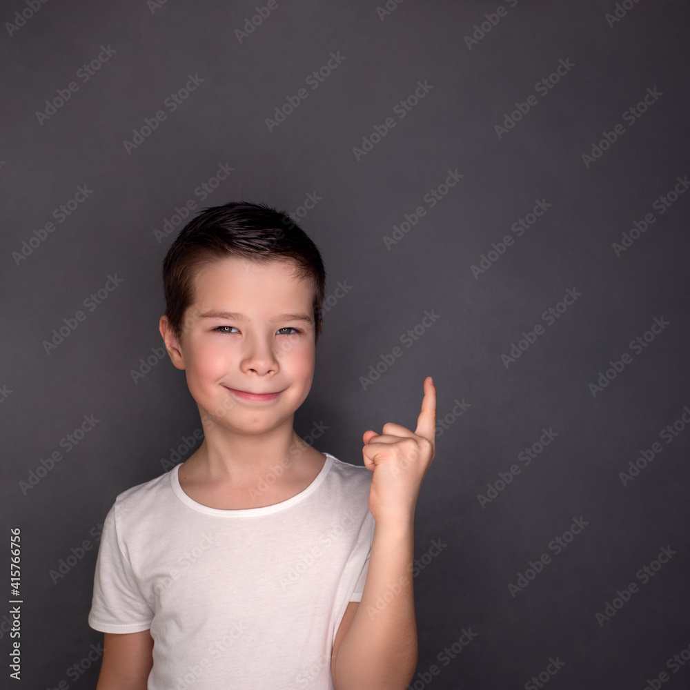 Handsome boy, cute baby face, points finger, lovely model
