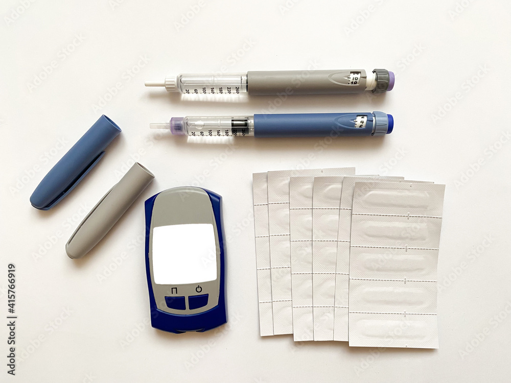 Insulin short, long, glucose meter and test strips on a white isolated background. Set for diabetics with mock up Insulin short, long, glucose meter and test strips on a white isolated background. Set for diabetics with mock up