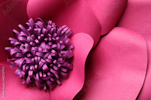 Beautiful pink flower made of paper as background, top view