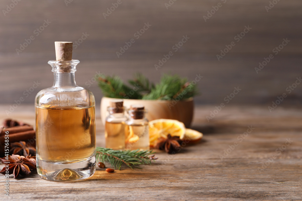 Anise essential oil and spices on wooden table, space for text Anise essential oil and spices on wooden table, space for text