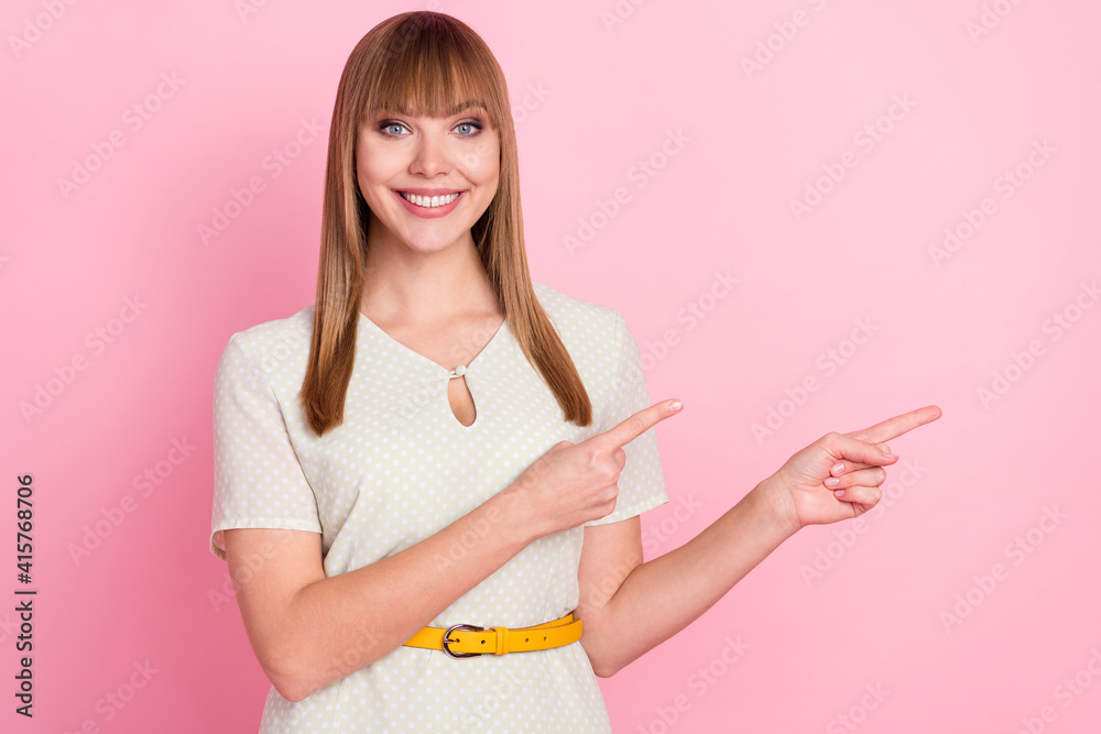 Portrait of attractive cheerful girl demonstrating copy space offer way ad isolated over pink pastel color background Portrait of attractive cheerful girl demonstrating copy space offer way ad isolated over pink pastel color background