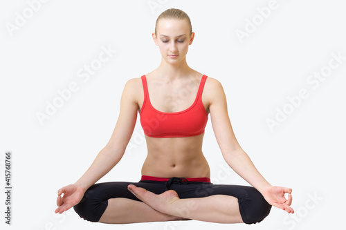 young blond hair woman in yoga pose siddhasana photo