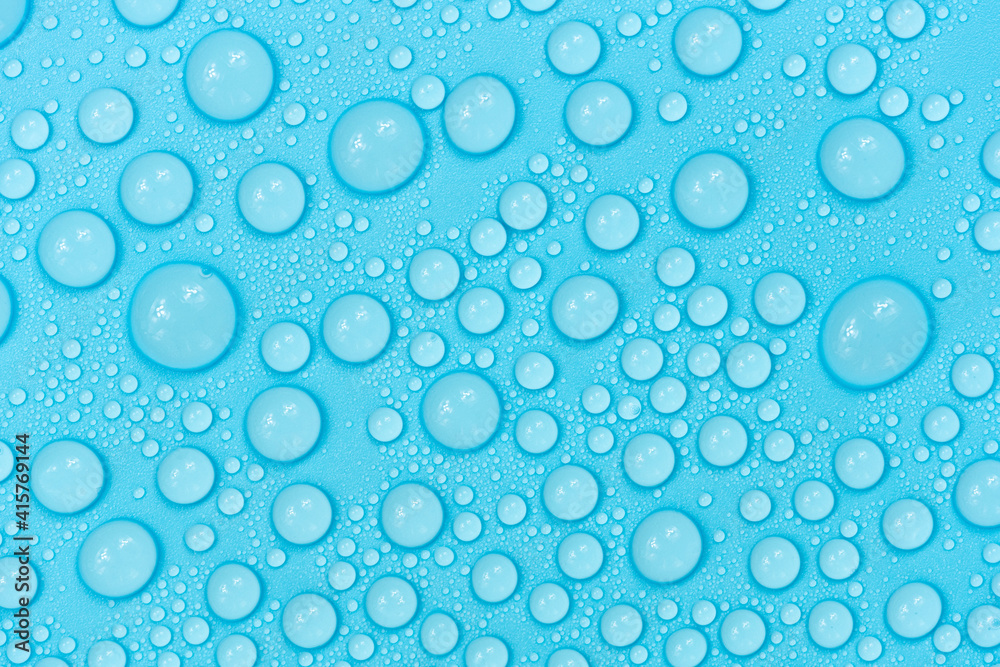 Water drops on blue background texture. Backdrop glass covered with drops of water. bubbles in water