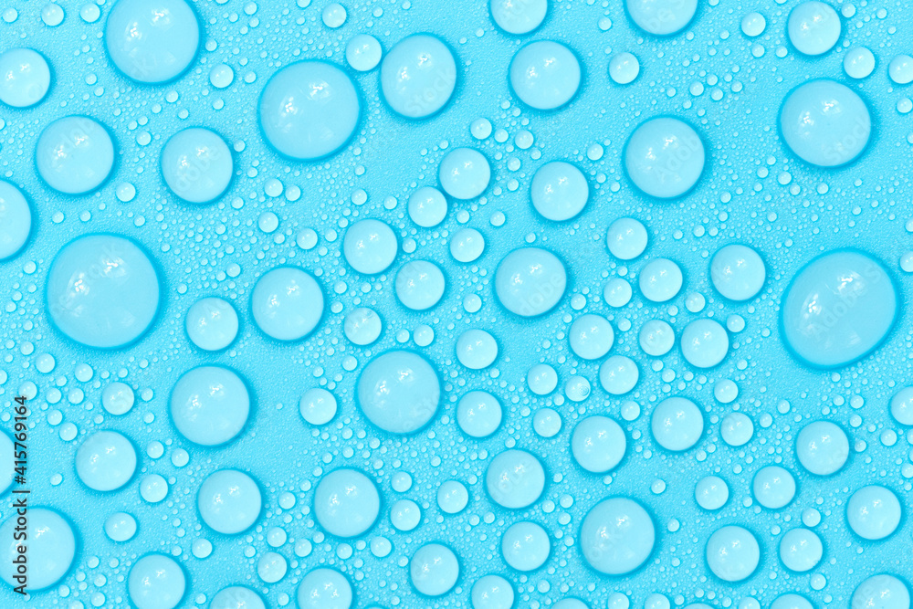 Water drops on blue background texture. Backdrop glass covered with drops of water. bubbles in water