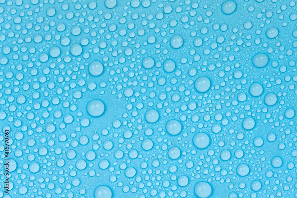 Water drops on blue background texture. Backdrop glass covered with drops of water. bubbles in water