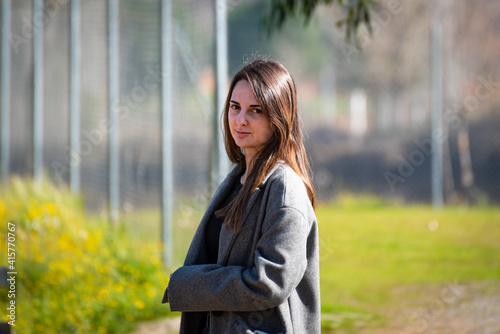 Free Download Beautiful young woman in a park staring intensely at the camera - GFXLoad