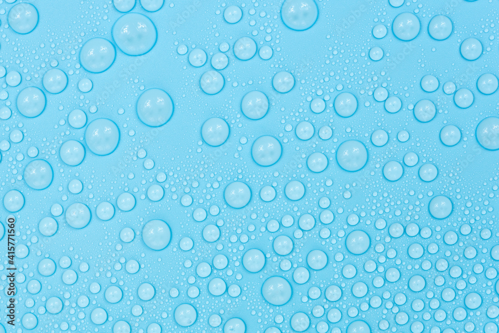 Water drops on blue background texture. Backdrop glass covered with drops of water. bubbles in water